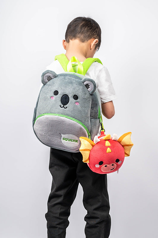 Roscoe The Dragon Travel Pillow Set Model Wearing A Backpack